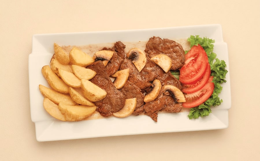 Brzola steak with wedges at Derian, Yerevan — Beef steak with mushrooms and thick potato wedges — the biggest single plate here, and the one to order hungry.