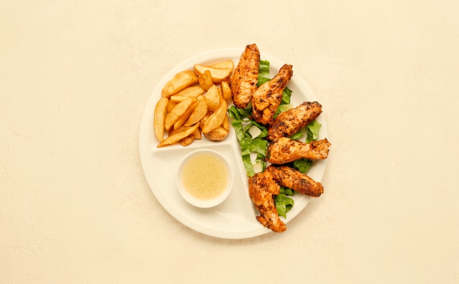 Chicken wings at Derian, Yerevan — Chicken wings rubbed with spices and grilled — sticky at the tips, and the plate that empties without anyone admitting it.