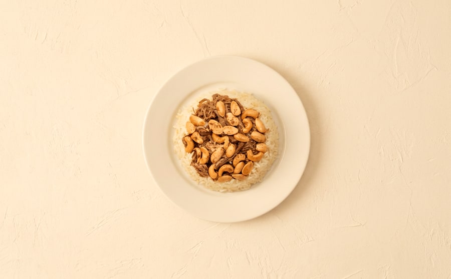 Ghawarma with rice at Derian, Yerevan — Preserved ghawarma meat over rice with nuts — dense, salty and old-fashioned, a plate that eats like deep winter.