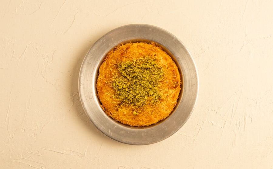 Kunafe with cheese at Derian, Yerevan — Fine semolina pastry over a layer of sweet cheese, soaked in syrup and served warm — the pull is the whole point.