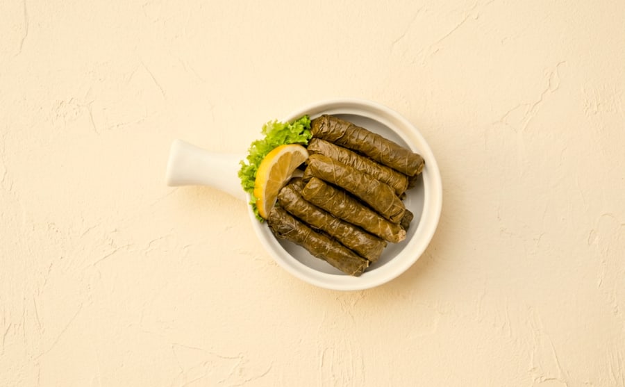 Sarma at Derian, Yerevan — Vine leaves rolled around meat and rice — plumper and richer than yalanchi, and served warm with yogurt and lemon.