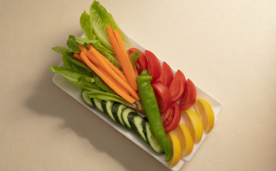 Seasonal vegetables at Derian, Yerevan — Whatever vegetables the season is giving, cut fresh and served cold — crisp, plain, and good between richer mouthfuls.