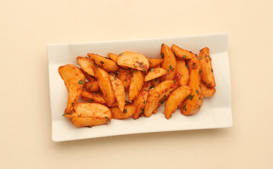Spicy wedges at Derian, Yerevan — Thick potato wedges under a heavy dust of spice — rough-edged, hot, and worth having a glass of water beside them.
