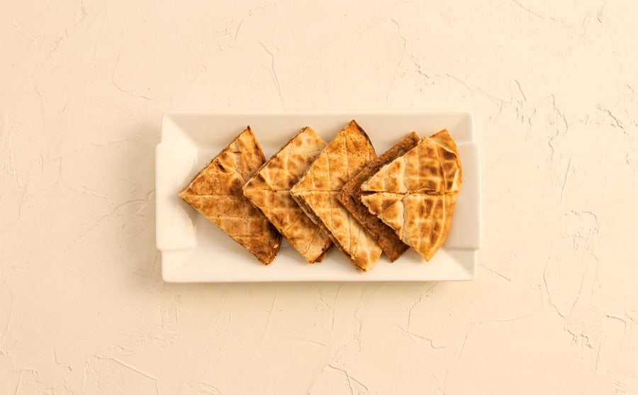 Toshka at Derian, Yerevan — Meat and cheese pressed into lavash and grilled — crisp outside, molten in the middle, and eaten hot or not at all.